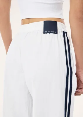 Relay spray track pant in white & dark navy
